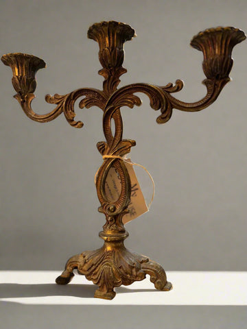 Vintage brass candleholder with bronze and gold finish, holds three candles, ornate decorative design